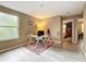 Home office with a white desk, comfortable chair, and view to the bedroom at 5050 Shorewood Landing Ln, Oviedo, FL 32765