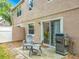 Covered back patio area with gas grill and outdoor seating with access to sliding glass doors at 5050 Shorewood Landing Ln, Oviedo, FL 32765