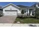 Charming single-story home featuring a two-car garage and a well-manicured front yard at 5268 Teirgarten St, St Cloud, FL 34771