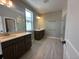 Bright bathroom featuring double sinks, a walk-in shower, and modern fixtures at 5330 Center Lake, St Cloud, FL 34771