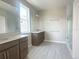 Bathroom featuring double sinks, vanity with solid surface countertop, and a walk-in shower at 5330 Center Lake, St Cloud, FL 34771