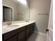 Well-lit bathroom featuring double sinks, vanity with solid surface countertop, and ample space at 5330 Center Lake, St Cloud, FL 34771