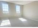 Bright, carpeted bedroom featuring natural light from the two windows at 5330 Center Lake, St Cloud, FL 34771