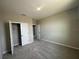 Neutral bedroom features a bright window, plush carpeting, and closet at 5330 Center Lake, St Cloud, FL 34771