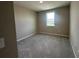 Comfortable bedroom with neutral walls, soft carpeting, and a window overlooking the neighborhood at 5330 Center Lake, St Cloud, FL 34771