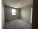 Cozy bedroom featuring neutral walls, plush carpet, and a bright window at 5330 Center Lake, St Cloud, FL 34771