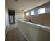 Bright hallway with neutral walls, carpet floor, white trim, and natural light streaming through multiple windows at 5330 Center Lake, St Cloud, FL 34771