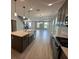 Open kitchen and living area with an island, pendant lighting, and stainless steel appliances at 5330 Center Lake, St Cloud, FL 34771