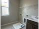Functional laundry room with sink, storage cabinets, and shelving for organization at 5330 Center Lake, St Cloud, FL 34771