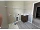 Functional laundry room with a utility sink, shelving, and tile flooring at 5330 Center Lake, St Cloud, FL 34771