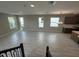 Open-concept living room featuring wood-look tile flooring and multiple windows providing ample natural light at 5330 Center Lake, St Cloud, FL 34771