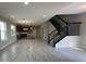 Expansive open layout connecting the living room, kitchen, and staircase with stylish tile floors at 5330 Center Lake, St Cloud, FL 34771