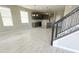 Living room with wood-look tile floors, kitchen view, and a modern staircase at 5330 Center Lake, St Cloud, FL 34771