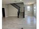 Open living area showcasing tile flooring, a staircase with black railings, and a bright entryway at 5330 Center Lake, St Cloud, FL 34771