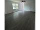 New living room featuring gray tiled floors, ceiling fan, and new windows at 563 Winogene Ave, Umatilla, FL 32784