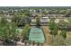 Aerial view of community tennis courts surrounded by lush trees in a residential neighborhood at 5943 Sunderland Dr, Orlando, FL 32812