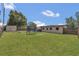 Expansive backyard features a trampoline, storage shed, playset and plenty of lawn at 5943 Sunderland Dr, Orlando, FL 32812
