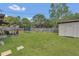 Large backyard with lush lawn, a trampoline, playset, shed, and outdoor seating area at 5943 Sunderland Dr, Orlando, FL 32812