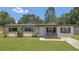 Charming single-story home with a well-manicured lawn and inviting front porch at 5943 Sunderland Dr, Orlando, FL 32812