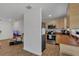 The kitchen features a stainless steel refrigerator, light wooden cabinets, wooden countertops and tile floors at 5943 Sunderland Dr, Orlando, FL 32812