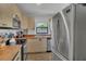Well-lit kitchen with stainless steel appliances, bright cabinets, wooden countertops and a window with backyard views at 5943 Sunderland Dr, Orlando, FL 32812