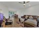 Inviting living room with lots of light, tile floors, modern ceiling fan, and direct access to the backyard at 5943 Sunderland Dr, Orlando, FL 32812