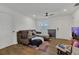 Bright living room with tile floors, a modern ceiling fan, neutral colors, and an open layout at 5943 Sunderland Dr, Orlando, FL 32812