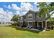 Inviting backyard with patio seating, well-maintained lawn, and lake view at 6672 S Goldenrod Rd # 132B, Orlando, FL 32822