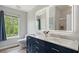 Modern bathroom features a dual sink vanity with framed mirrors and marble countertop at 6672 S Goldenrod Rd # 132B, Orlando, FL 32822
