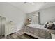 This bedroom includes a TV, desk, dresser and window to let in sunlight at 6672 S Goldenrod Rd # 132B, Orlando, FL 32822