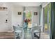 Bright dining room boasts a glass table, stylish blue chairs, and a modern chandelier at 6672 S Goldenrod Rd # 132B, Orlando, FL 32822
