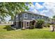 A two-story townhome has a patio with seating overlooking a large lawn and a serene lake at 6672 S Goldenrod Rd # 132B, Orlando, FL 32822