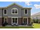 Townhouse with a private patio, lush lawn, and modern two-tone exterior at 6672 S Goldenrod Rd # 132B, Orlando, FL 32822