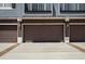 Attached three-car garage with brown doors and well-kept driveway at 6672 S Goldenrod Rd # 132B, Orlando, FL 32822