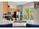 Kitchen featuring stainless steel appliances, a large window, and stylish countertops at 6672 S Goldenrod Rd # 132B, Orlando, FL 32822