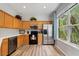 Kitchen featuring stainless steel appliances, light wood cabinets, granite countertops, and wood flooring at 6672 S Goldenrod Rd # 132B, Orlando, FL 32822