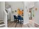 Kitchen showcasing breakfast bar with adjacent staircase, light wood cabinets, and stainless steel appliances at 6672 S Goldenrod Rd # 132B, Orlando, FL 32822