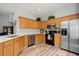 Bright kitchen with light-colored wood cabinets, stainless steel appliances, and modern countertops at 6672 S Goldenrod Rd # 132B, Orlando, FL 32822