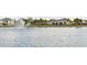 View of the lake and water fountain highlighting community amenities and neighborhood homes at 6672 S Goldenrod Rd # 132B, Orlando, FL 32822