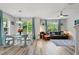 Bright open living space with modern furniture, wood floors, and large windows with vibrant green views at 6672 S Goldenrod Rd # 132B, Orlando, FL 32822