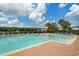 Community swimming pool with sun loungers and well-maintained landscaping on a sunny day at 6672 S Goldenrod Rd # 132B, Orlando, FL 32822