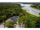 Aerial view of a home with an enclosed pool, next to a lush green lake at 810 Alex Ln, Deltona, FL 32738