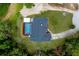 Aerial view of home with enclosed pool and deck in a landscaped yard, surrounded by trees at 810 Alex Ln, Deltona, FL 32738