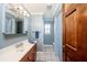 Cozy bathroom with a wood vanity, tile flooring, and walk-in shower with modern fixtures at 810 Alex Ln, Deltona, FL 32738
