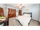 Bedroom with a patterned bed, a ceiling fan, closet, and light grey walls and carpet at 810 Alex Ln, Deltona, FL 32738