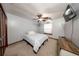 Bedroom with light grey walls, a window, a ceiling fan, and a mounted TV on the wall at 810 Alex Ln, Deltona, FL 32738