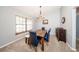 Dining room with hardwood table and seating under a chandelier, filled with natural light at 810 Alex Ln, Deltona, FL 32738