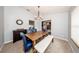 Dining room with rustic table and stylish blue chairs, with views into other rooms at 810 Alex Ln, Deltona, FL 32738