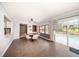 Dining area with view of the pool, with a view to the kitchen and an exterior door at 810 Alex Ln, Deltona, FL 32738