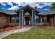 Close up of the front entrance with brick facade and lush flowerbeds surrounding the sidewalk at 810 Alex Ln, Deltona, FL 32738